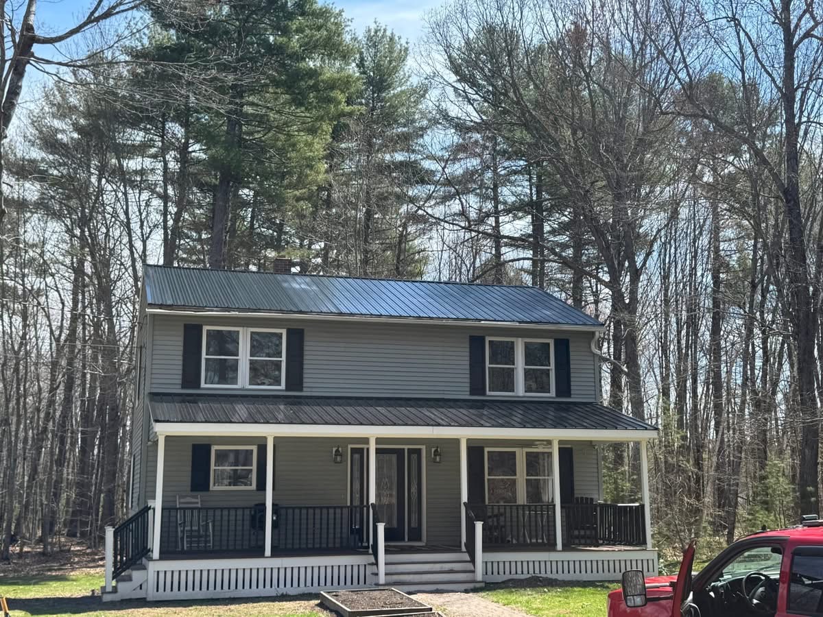 Two-story Maine home with new metal roof and gray siding