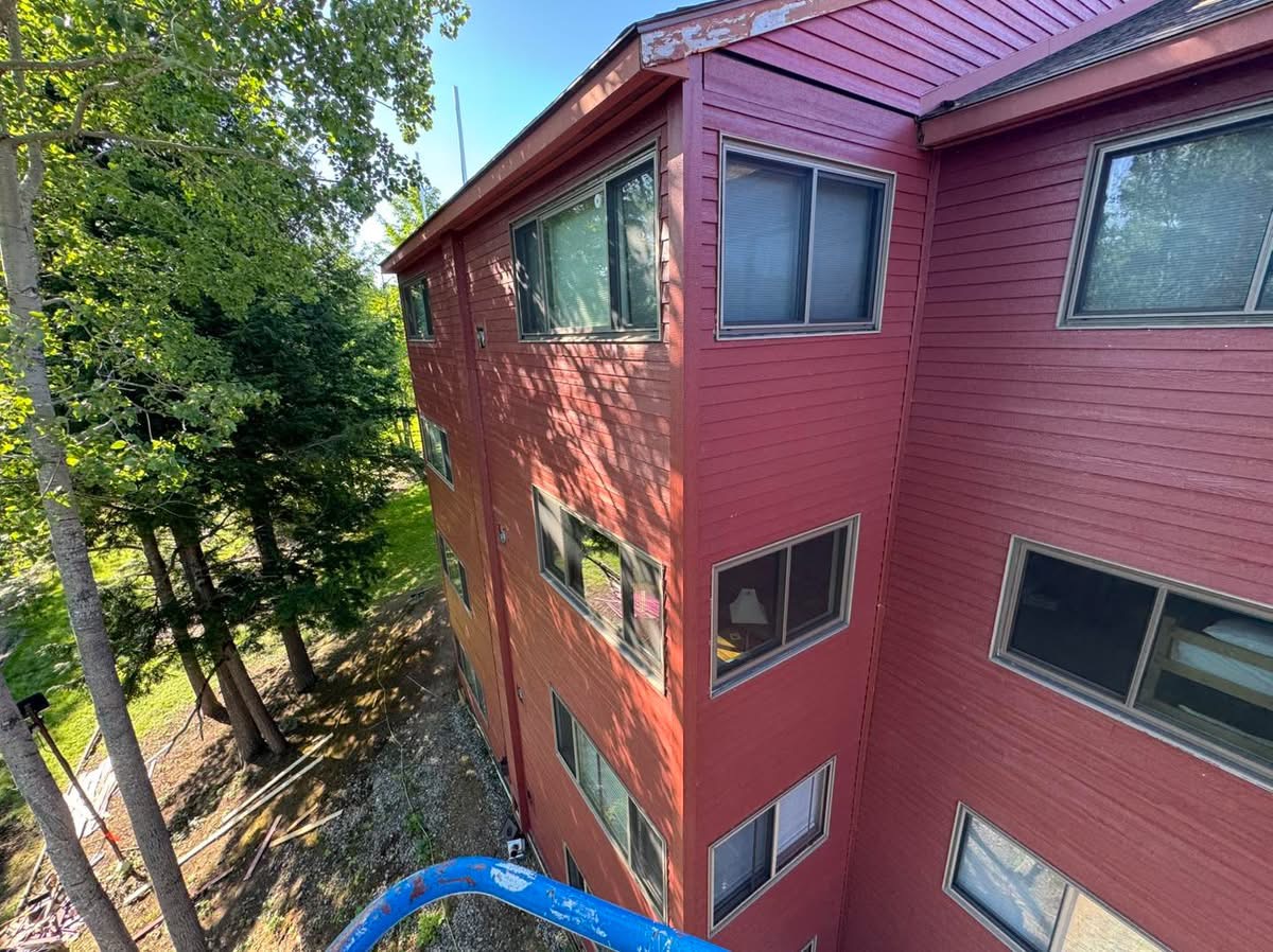 Three-story red wood siding installation