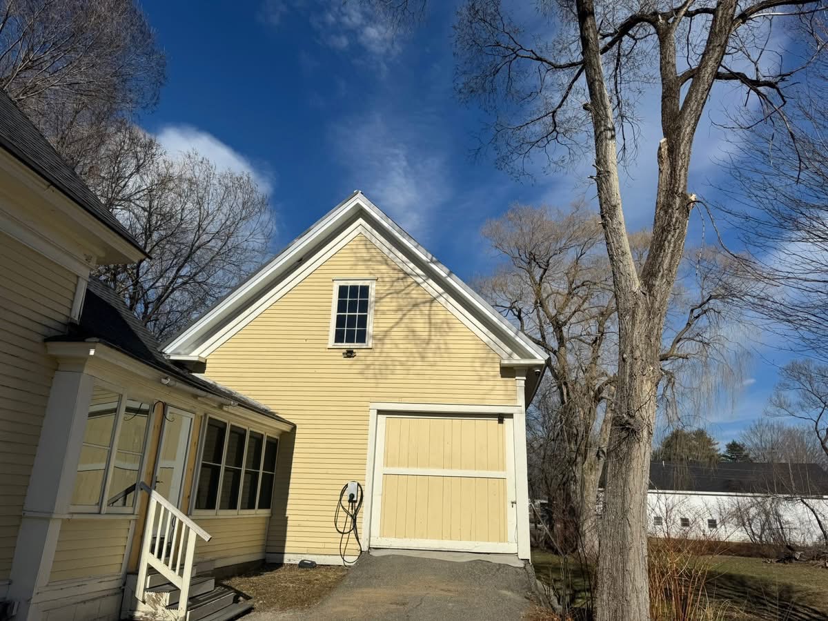 Yellow farmhouse exterior with fresh trim