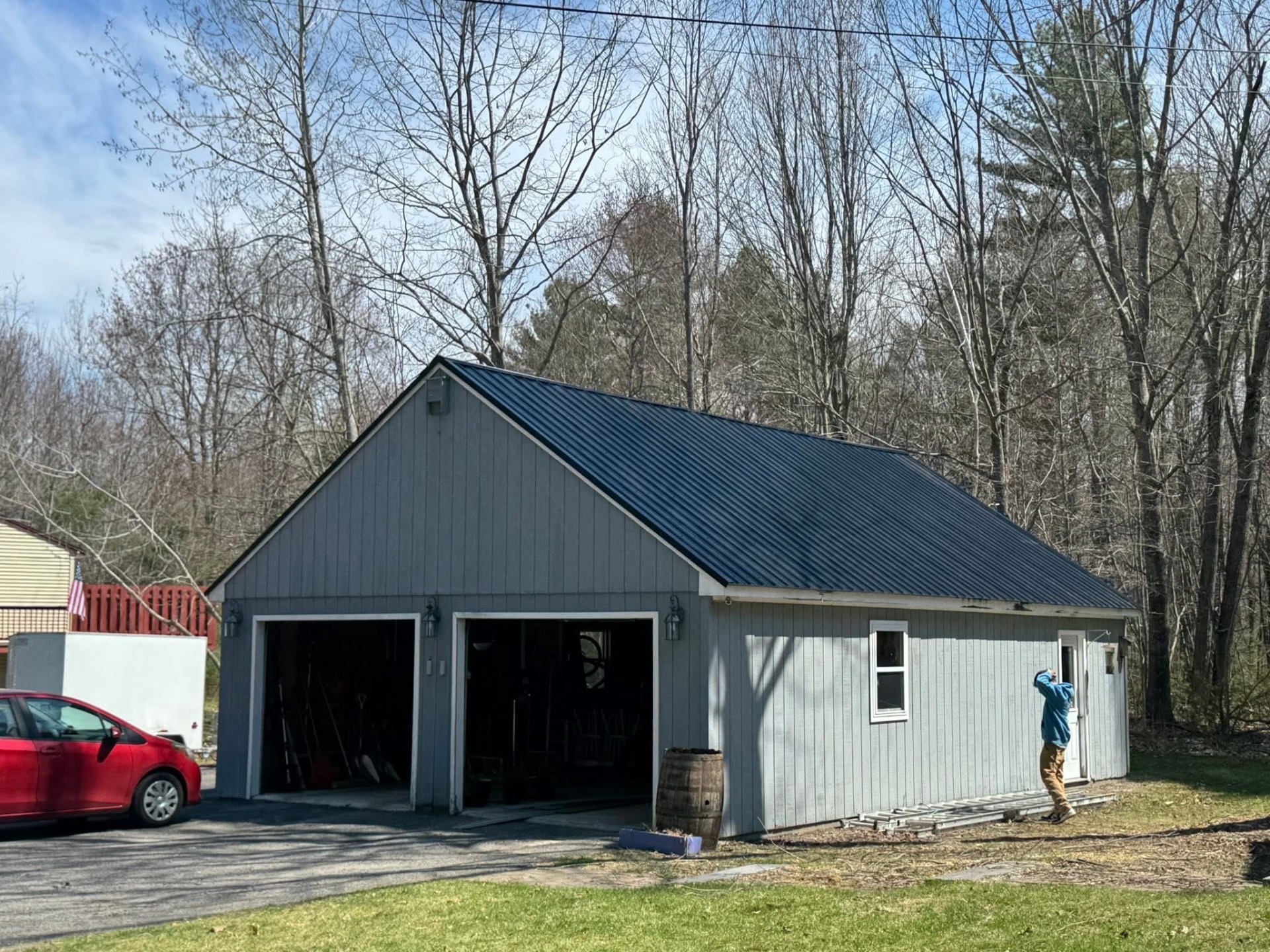 Detached garage with dark metal roof and board-and-batten siding
