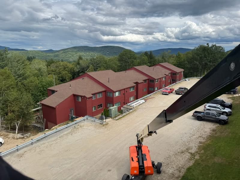 Large commercial building with new red metal roof