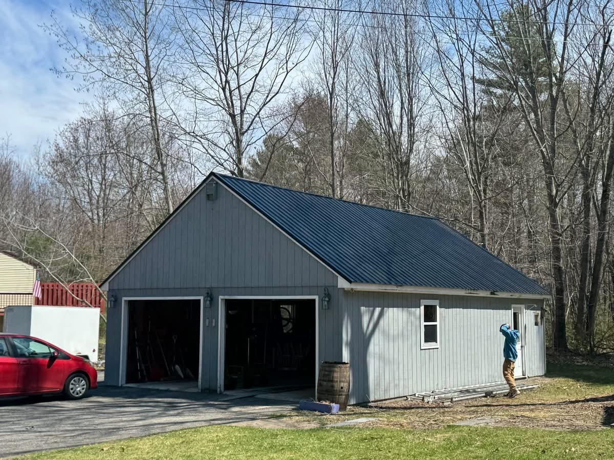 Garage with new dark metal roof and gray siding